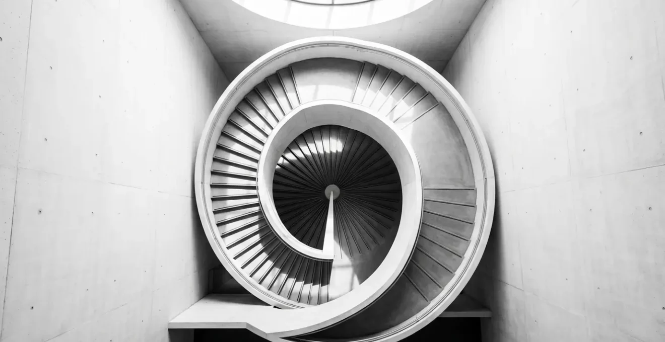 Vue aérienne d'un escalier en colimaçon symbolisant la montée et descente du bonus-malus